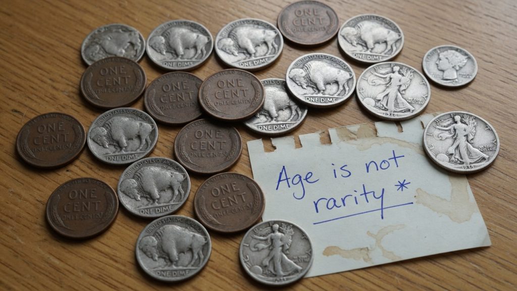 Spread of worn wheat cents, nickels, dimes and halves illustrating that old coins are often common