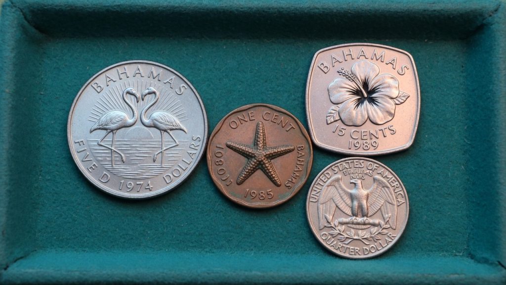 Bahamas five-dollar flamingos, a starfish cent, a square 15-cent hibiscus, and a US quarter