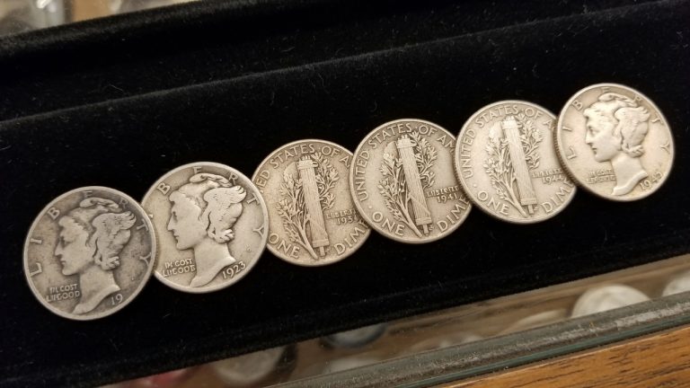A row of Mercury dimes on black velvet showing more remaining design from left to right