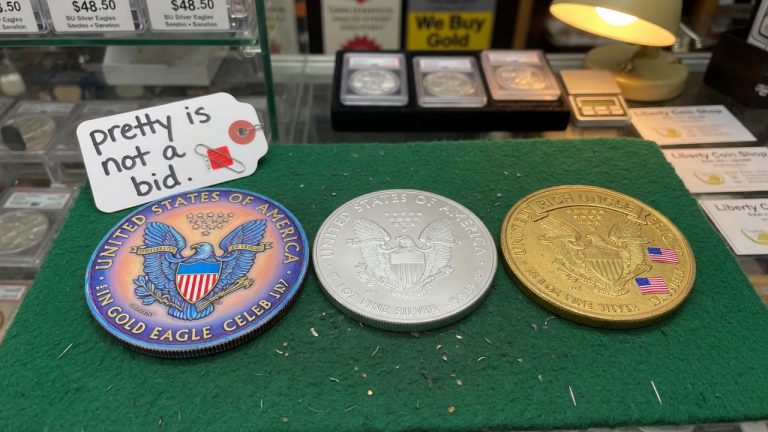 A colorized novelty, a plain silver eagle-style coin, and a gold-plated novelty tagged pretty is not a bid