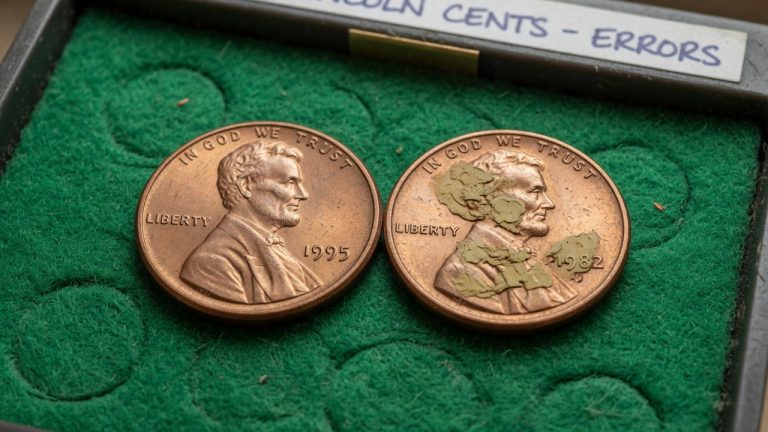 Two US cents on green felt showing a doubled date and a strike problem