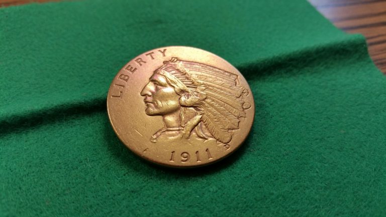 A United States $5 Indian Head gold coin on green felt