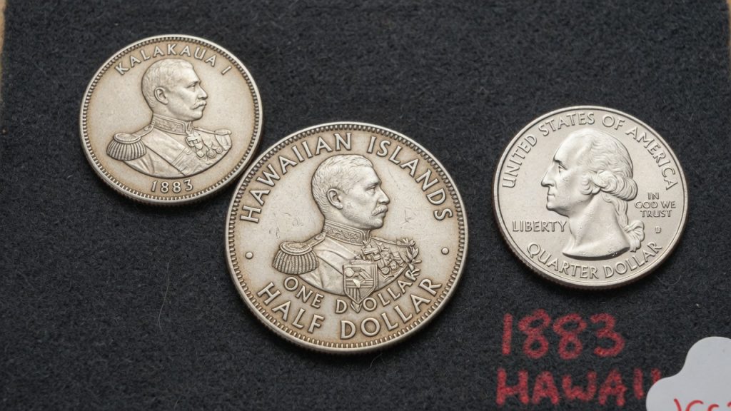1883 Hawaiian Islands Kalakaua silver coins beside a US quarter