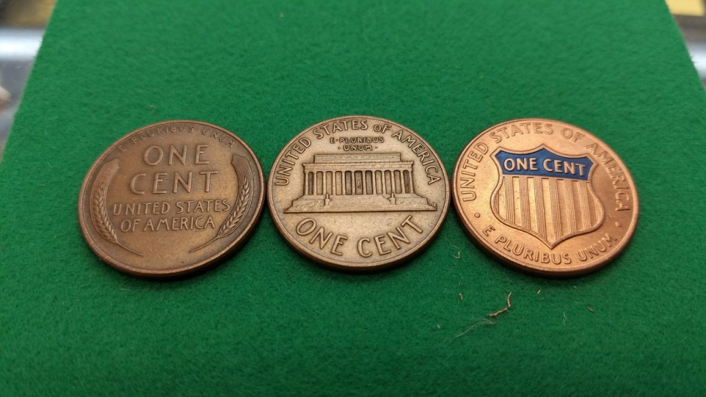 Wheat, Memorial, and Shield Lincoln cents on green felt