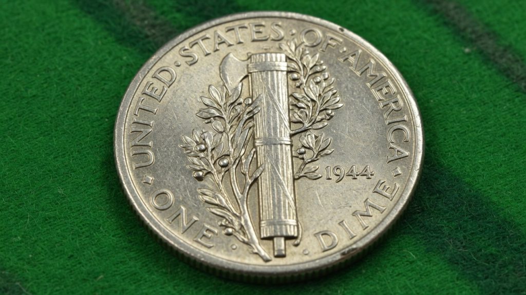 Mercury dime reverse showing the fasces and olive branch on green felt