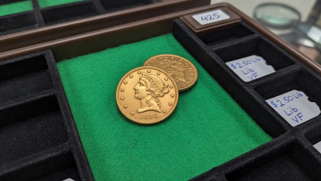 A United States $2.50 Liberty gold coin on green felt