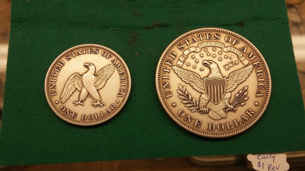 Two silver-dollar reverses: a small early eagle and a larger heraldic eagle with shield, olive branch, and arrows