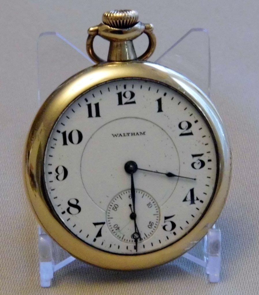 Open-face Waltham pocket watch; the case is an Illinois Watch Case Co. Empire guaranteed 25 years